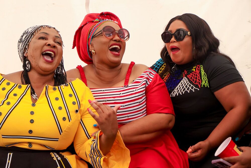Three Nigerian women laughing together